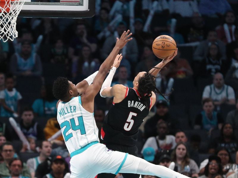 CHARLOTTE, NC - APRIL 3:  Dalano Banton #5 of the Portland Trail Blazers drives to the basket during the game as Brandon Miller #24 of the Charlotte Hornets plays defense on April 3, 2024 at Spectrum Center in Charlotte, North Carolina. NOTE TO USER: User expressly acknowledges and agrees that, by downloading and or using this photograph, User is consenting to the terms and conditions of the Getty Images License Agreement.  Mandatory Copyright Notice:  Copyright 2024 NBAE (Photo by Brock Williams-Smith/NBAE via Getty Images)