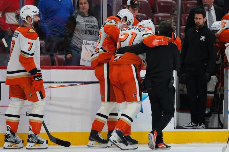 Jan 18, 2025; Sunrise, Florida, USA; Anaheim Ducks center Isac Lundestrom (21) is helped getting off the ice after an apparent injury against the Florida Panthers during the first period at Amerant Bank Arena. Mandatory Credit: Sam Navarro-Imagn Images