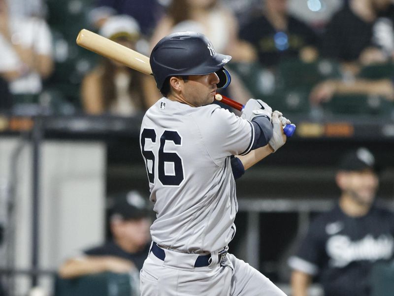 Aug 8, 2023; Chicago, Illinois, USA; New York Yankees catcher Kyle Higashioka (66) hits a two-run home run against the Chicago White Sox during the eighth inning at Guaranteed Rate Field. Mandatory Credit: Kamil Krzaczynski-USA TODAY Sports