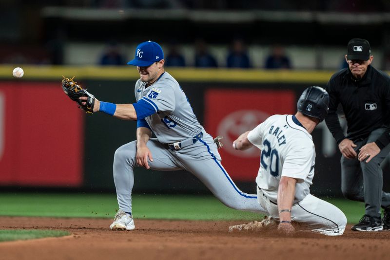 May 13, 2024; Seattle, Washington, USA; Seattle Mariners left fielder Luke Raley (20) steals second base as the throw gets away from second baseman Michael Massey (19) during the eighth inning at T-Mobile Park. Mandatory Credit: Stephen Brashear-USA TODAY Sports