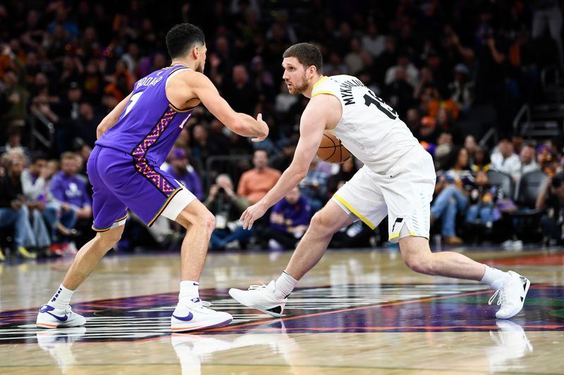 PHOENIX, ARIZONA - JANUARY 11: Svi Mykhailiuk #19 of the Utah Jazz controls the ball against Devin Booker #1 of the Phoenix Suns during the second half of the NBA game at Footprint Center on January 11, 2025 in Phoenix, Arizona. NOTE TO USER: User expressly acknowledges and agrees that, by downloading and or using this photograph, User is consenting to the terms and conditions of the Getty Images License Agreement. (Photo by Kelsey Grant/Getty Images)