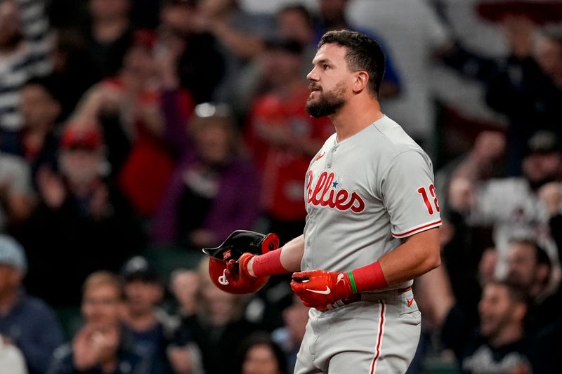 Oct 12, 2022; Atlanta, Georgia, USA; Philadelphia Phillies left fielder Kyle Schwarber (12) throws his helmet after striking out against the Atlanta Braves in the eighth inning during game two of the NLDS for the 2022 MLB Playoffs at Truist Park. Mandatory Credit: Dale Zanine-USA TODAY Sports