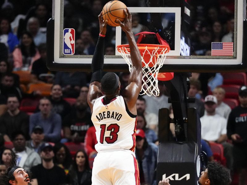 MIAMI, FLORIDA - JANUARY 08: Bam Adebayo #13 of the Miami Heat goes up for a dunk over Jalen Green #4 of the Houston Rockets during the third quarter at Kaseya Center on January 08, 2024 in Miami, Florida. NOTE TO USER: User expressly acknowledges and agrees that, by downloading and or using this photograph, User is consenting to the terms and conditions of the Getty Images License Agreement. (Photo by Rich Storry/Getty Images)