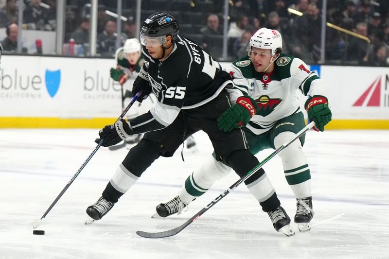 Apr 15, 2024; Los Angeles, California, USA; LA Kings right wing Quinton Byfield (55) and Minnesota Wild defenseman Brock Faber (7) battle for the puck in the second period at Crypto.com Arena. Mandatory Credit: Kirby Lee-USA TODAY Sports