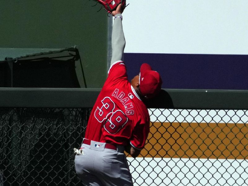 Mar 4, 2024; Surprise, Arizona, USA; Los Angeles Angels left fielder Jordyn Adams (39) is unable to catch a home run ball hit by Texas Rangers second baseman Marcus Semien (not pictured) during the third inning at Surprise Stadium. Mandatory Credit: Joe Camporeale-USA TODAY Sports