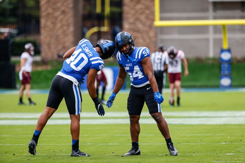 Nov 12, 2022; Durham, North Carolina, USA;  Duke Blue Devils linebacker Jason Hoffman (54) and defensive end Ryan Smith (40) shakes just before the first half against Virginia Tech at Wallace Wade Stadium. Mandatory Credit: Jaylynn Nash-USA TODAY Sports