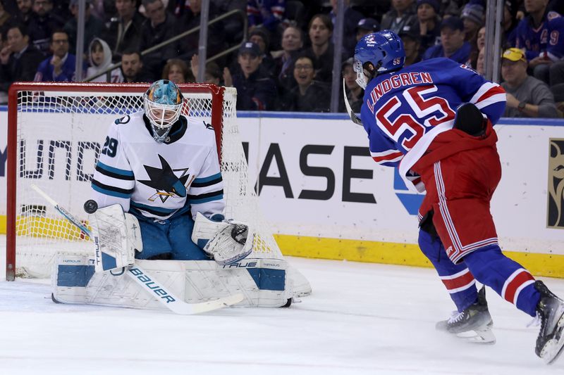 Nov 14, 2024; New York, New York, USA; San Jose Sharks goaltender Mackenzie Blackwood (29) makes a save against New York Rangers defenseman Ryan Lindgren (55) during the first period at Madison Square Garden. Mandatory Credit: Brad Penner-Imagn Images