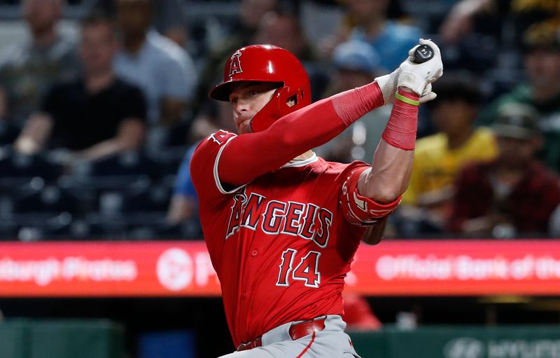 May 7, 2024; Pittsburgh, Pennsylvania, USA;  Los Angeles Angels catcher Logan O'Hoppe (14) hits an RBI single against the Pittsburgh Pirates during the eighth inning at PNC Park. Mandatory Credit: Charles LeClaire-USA TODAY Sports