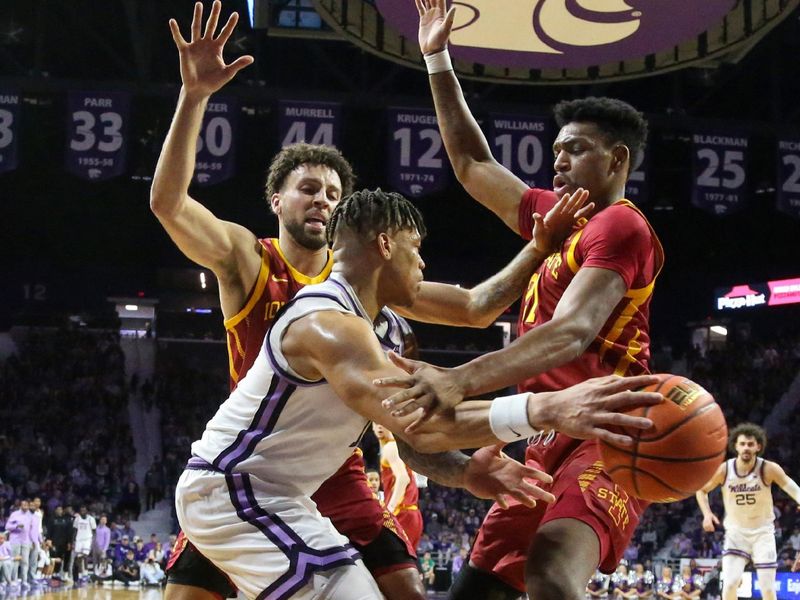 Feb 18, 2023; Manhattan, Kansas, USA; Kansas State Wildcats guard Keyontae Johnson (11) passes the ball around Iowa State Cyclones forward Osun Osunniyi (21) and guard Gabe Kalscheur (22) during the first half at Bramlage Coliseum. Mandatory Credit: Scott Sewell-USA TODAY Sports