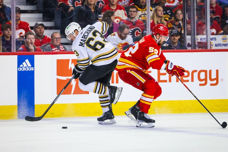 Feb 22, 2024; Calgary, Alberta, CAN; Boston Bruins left wing Brad Marchand (63) controls the puck against Calgary Flames defenseman MacKenzie Weegar (52) during the first period at Scotiabank Saddledome. Mandatory Credit: Sergei Belski-USA TODAY Sports