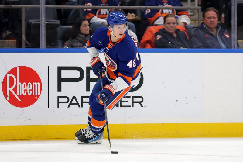 Dec 2, 2025; Elmont, New York, USA; New York Islanders defenseman Matthew Schaefer (48) skates with the puck against the Tampa Bay Lightning during the first period at UBS Arena. Mandatory Credit: Brad Penner-Imagn Images