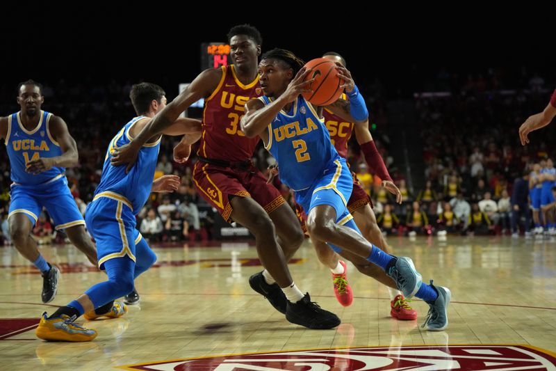 Jan 27, 2024; Los Angeles, California, USA; UCLA Bruins guard Dylan Andrews (2) moves the basket against Southern California Trojans forward Kijani Wright (33) in the first half at Galen Center. Mandatory Credit: Kirby Lee-USA TODAY Sports