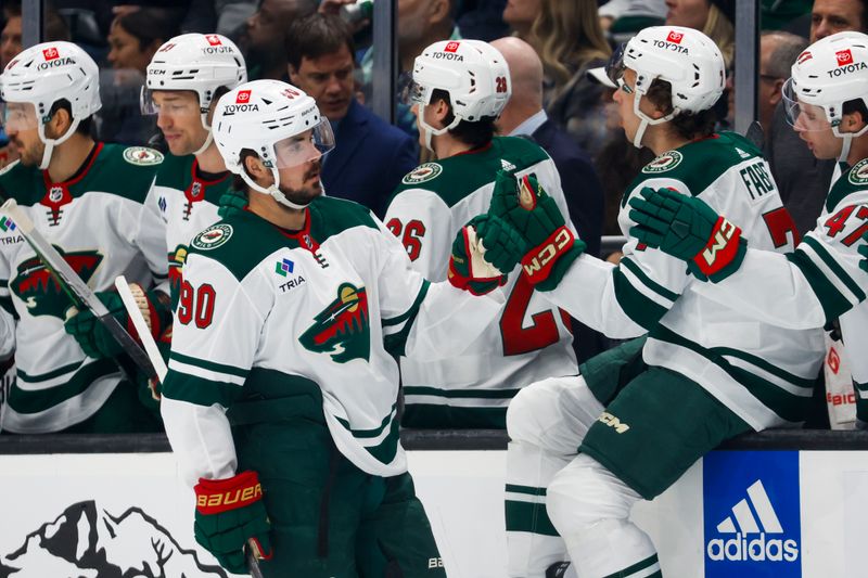 Feb 24, 2024; Seattle, Washington, USA; Minnesota Wild left wing Marcus Johansson (90) celebrates with teammates on the bench after scoring a goal against the Seattle Kraken during the first period at Climate Pledge Arena. Mandatory Credit: Joe Nicholson-USA TODAY Sports