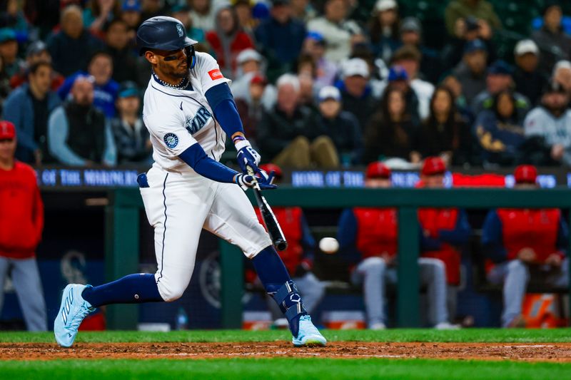 Apr 29, 2025; Seattle, Washington, USA; Seattle Mariners center fielder Julio Rodríguez (44) hits an infield-single against the Los Angeles Angels during the seventh inning at T-Mobile Park. Mandatory Credit: Joe Nicholson-Imagn Images