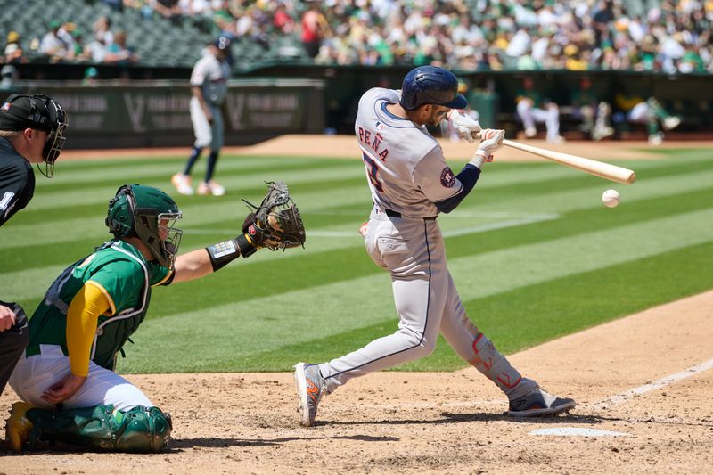 May 26, 2024; Oakland, California, USA; Houston Astros infielder Jeremy Pena (3) hits a single against the Oakland Athletics during the seventh inning at Oakland-Alameda County Coliseum. Mandatory Credit: Robert Edwards-USA TODAY Sports