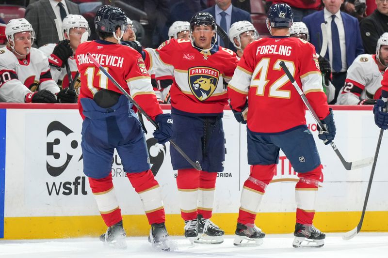 Oct 11, 2025; Sunrise, Florida, USA;  Florida Panthers left wing Brad Marchand (63) celebrates a goal against the Ottawa Senators with right wing Mackie Samoskevich (11) and defenseman Gustav Forsling (42) during the first period at Amerant Bank Arena. Mandatory Credit: Jim Rassol-Imagn Images