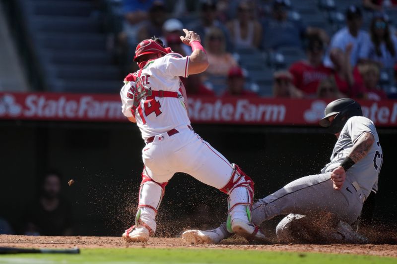 Sep 18, 2024; Anaheim, California, USA; Chicago White Sox catcher Korey Lee (26) slides into home plate to beat a throw to Los Angeles Angels catcher Logan O'Hoppe (14) to score in the 10th inning at Angel Stadium. Mandatory Credit: Kirby Lee-Imagn Images