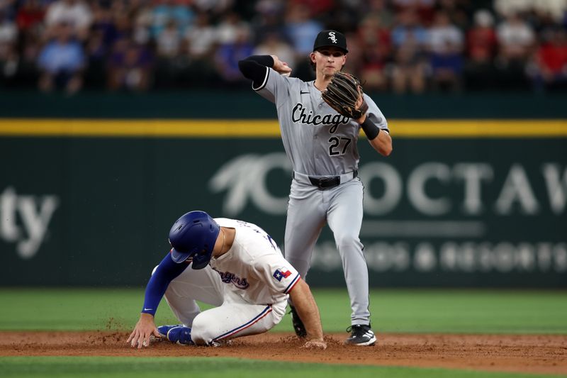 Jul 25, 2024; Arlington, Texas, USA;  Chicago White Sox second base Brooks Baldwin (27) turns a double play against Texas Rangers shortstop Corey Seager (5) in the third inning at Globe Life Field. Mandatory Credit: Tim Heitman-USA TODAY Sports