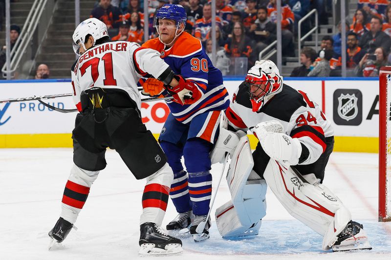 Nov 4, 2024; Edmonton, Alberta, CAN; Edmonton Oilers forward Corey Perry (90) battles with New Jersey Devils defensemen Jonas Siegenthaler (71) in front of goaltender Jake Allen (34) during the third period at Rogers Place. Mandatory Credit: Perry Nelson-Imagn Images