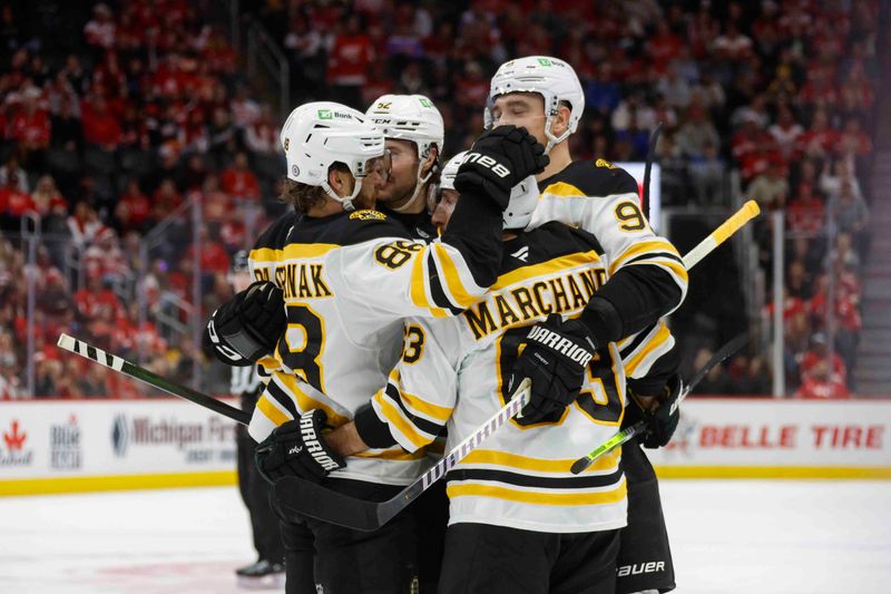 Nov 23, 2024; Detroit, Michigan, USA; The Boston Bruins celebrate a goal by Boston Bruins left wing Brad Marchand (63) during the third period at Little Caesars Arena. Mandatory Credit: Brian Bradshaw Sevald-Imagn Images