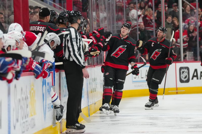 Jan 1, 2026; Raleigh, North Carolina, USA; Carolina Hurricanes defenseman Alexander Nikishin (21) celebrates his goal against the Montréal Canadiens during the second period at Lenovo Center. Mandatory Credit: James Guillory-Imagn Images Jan 1, 2026; Raleigh, North Carolina, USA; Carolina Hurricanes defenseman Alexander Nikishin (21) celebrates his goal against the Montréal Canadiens during the second period at Lenovo Center. Mandatory Credit: James Guillory-Imagn Images