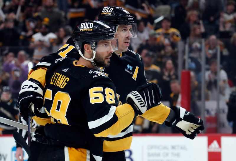 Feb 22, 2024; Pittsburgh, Pennsylvania, USA; Pittsburgh Penguins center Evgeni Malkin (71) congratulates defenseman Kris Letang (58) after Letang scored a goal against the Montreal Canadiens during the first period at PPG Paints Arena. Mandatory Credit: Charles LeClaire-USA TODAY Sports