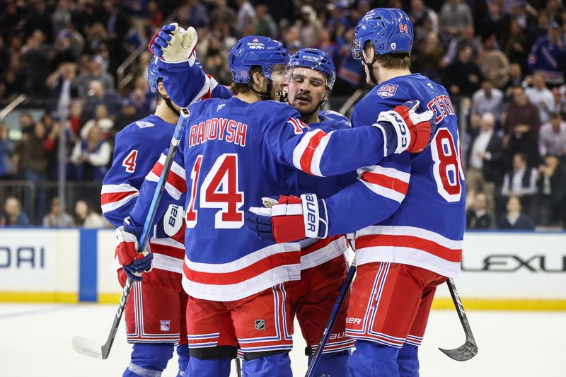 Oct 23, 2025; New York, New York, USA;  New York Rangers right wing Taylor Raddysh (14) celebrates with his teammates after scoring a goal in the first period against the San Jose Sharks at Madison Square Garden. Mandatory Credit: Wendell Cruz-Imagn Images