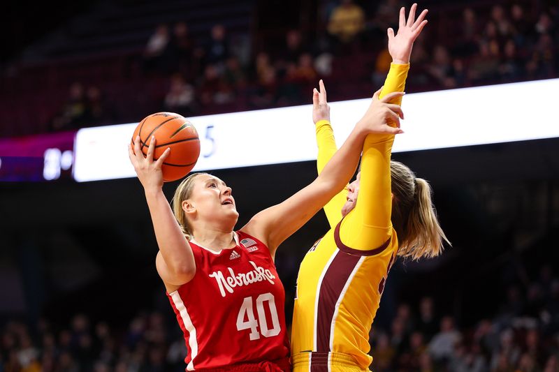 Jan 14, 2024; Minneapolis, Minnesota, USA; Nebraska Cornhuskers center Alexis Markowski (40) shoots as Minnesota Golden Gophers center Sophie Hart (52) defends during the second half at Williams Arena. Mandatory Credit: Matt Krohn-USA TODAY Sports