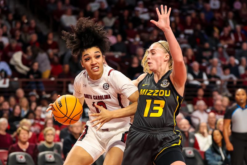 Jan 15, 2023; Columbia, South Carolina, USA; South Carolina Gamecocks guard Brea Beal (12) drives around Missouri Tigers guard Haley Troup (13) in the first half at Colonial Life Arena. Mandatory Credit: Jeff Blake-USA TODAY Sports