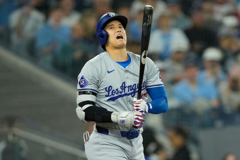 Apr 28, 2024; Toronto, Ontario, CAN; Los Angeles Dodgers designated hitter Shohei Ohtani (17) reacts after a strike against the Toronto Blue Jays during the first inning at Rogers Centre. Mandatory Credit: John E. Sokolowski-USA TODAY Sports