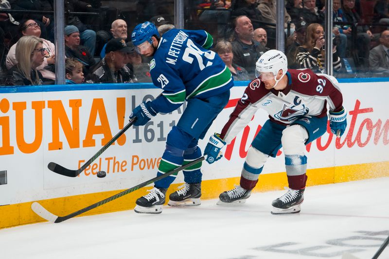 Nov 9, 2025; Vancouver, British Columbia, CAN; Colorado Avalanche forward Gabriel Landeskog (92) stick checks Vancouver Canucks defenseman Marcus Pettersson (29) in the first period at Rogers Arena. Mandatory Credit: Bob Frid-Imagn Images