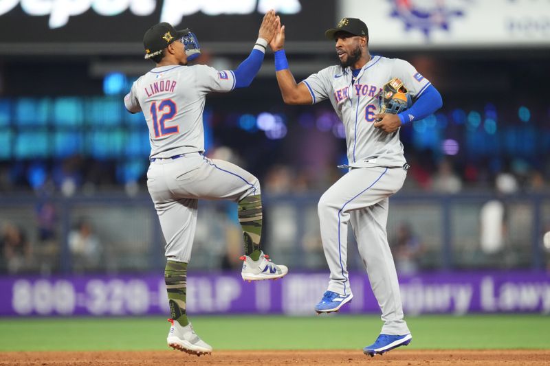 May 19, 2024; Miami, Florida, USA;  New York Mets outfielder Starling Marte (6) and shortstop Francisco Lindor (12) celebrate a victory over the Miami Marlins at loanDepot Park. Mandatory Credit: Jim Rassol-USA TODAY Sports