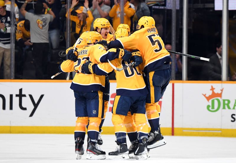 Apr 4, 2023; Nashville, Tennessee, USA; Nashville Predators players celebrate after the game-winning goal in overtime by center Cody Glass (8) against the Vegas Golden Knights at Bridgestone Arena. Mandatory Credit: Christopher Hanewinckel-USA TODAY Sports