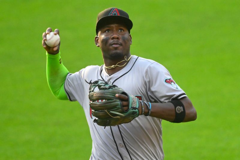 Aug 5, 2024; Cleveland, Ohio, USA; Arizona Diamondbacks shortstop Geraldo Perdomo (2) looks to throw the ball to fans at the end of the first inning against the Cleveland Guardians at Progressive Field. Mandatory Credit: David Richard-USA TODAY Sports