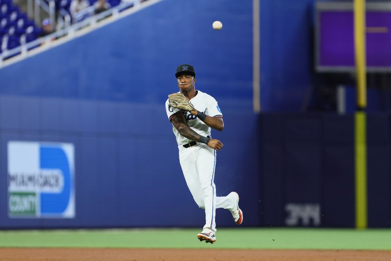 Apr 17, 2024; Miami, Florida, USA; Miami Marlins shortstop Tim Anderson (7) throws to first base and retires San Francisco Giants right fielder Austin Slater (not pictured) during the first inning at loanDepot Park. Mandatory Credit: Sam Navarro-USA TODAY Sports