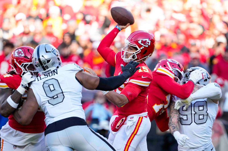 Kansas City Chiefs quarterback Patrick Mahomes (15) throws against the Las Vegas Raiders during the first half of an NFL football game in Kansas City, Mo., Friday, Nov. 29, 2024. (AP Photo/Ed Zurga)