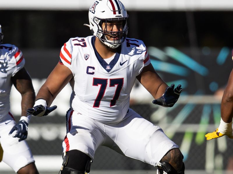 Nov 25, 2023; Tempe, Arizona, USA; Arizona Wildcats offensive lineman Jordan Morgan (77) against the Arizona State Sun Devils during the Territorial Cup at Mountain America Stadium. Mandatory Credit: Mark J. Rebilas-USA TODAY Sports