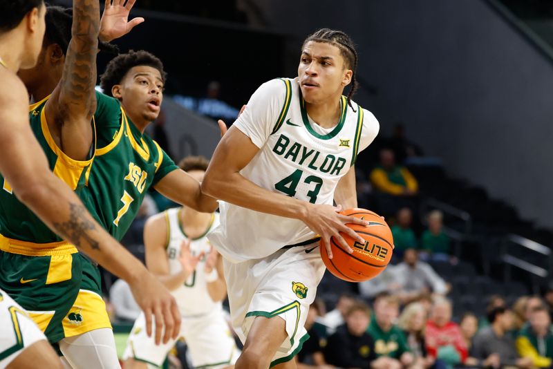 Dec 10, 2025; Waco, Texas, USA;  Baylor Bears guard Cameron Carr (43) drives to the basket against Norfolk State Spartans guard Anthony McComb III (7) during the first half at Paul and Alejandra Foster Pavilion. Mandatory Credit: Chris Jones-Imagn Images