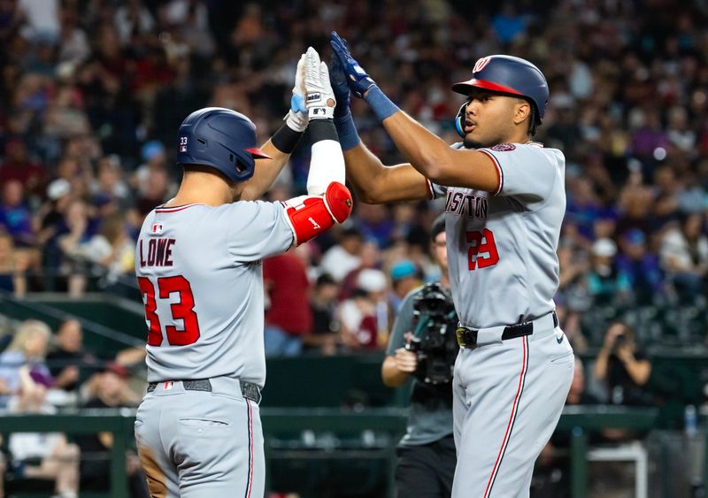 May 30, 2025; Phoenix, Arizona, USA; Washington Nationals outfielder James Wood (right) celebrates with Nathaniel Lowe after hitting a solo home run in the third inning against the Arizona Diamondbacks at Chase Field. Mandatory Credit: Mark J. Rebilas-Imagn Images