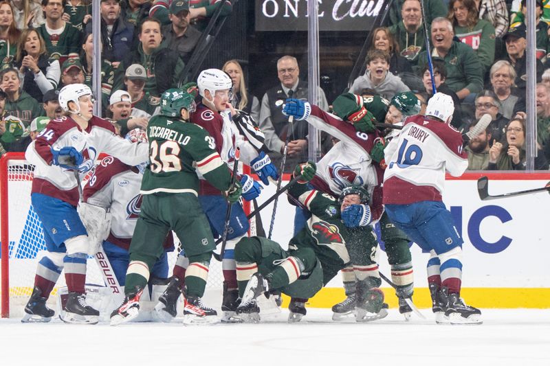 Mar 11, 2025; Saint Paul, Minnesota, USA; Minnesota Wild center Marco Rossi (23) is taken down by Colorado Avalanche defenseman Samuel Girard (49) in the first period at Xcel Energy Center. Mandatory Credit: Matt Blewett-Imagn Images