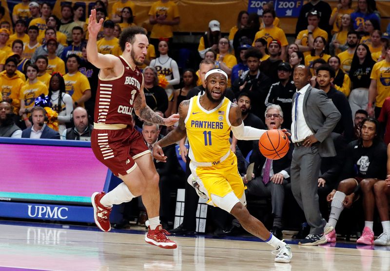 Feb 14, 2023; Pittsburgh, Pennsylvania, USA;  Pittsburgh Panthers guard Jamarius Burton (11) dribbles the ball around Boston College Eagles guard Jaeden Zackery (3) during the first half at the Petersen Events Center. Mandatory Credit: Charles LeClaire-USA TODAY Sports