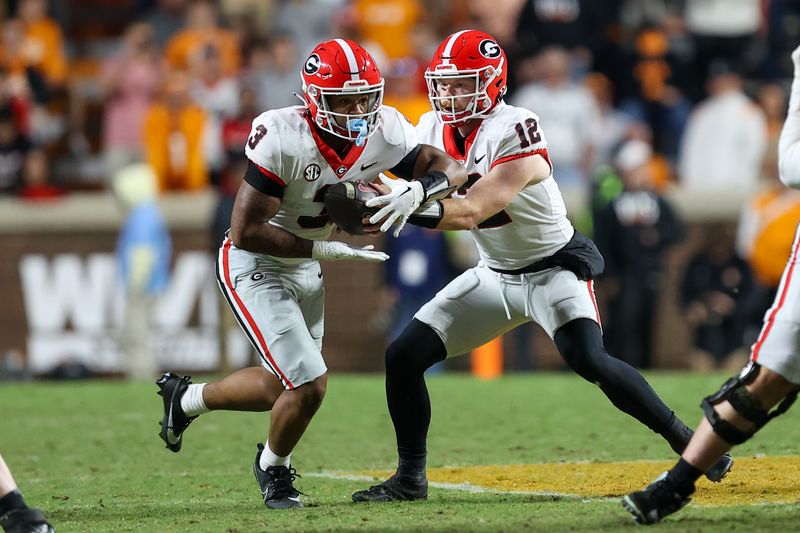 Nov 18, 2023; Knoxville, Tennessee, USA; Georgia Bulldogs running back Andrew Paul (3) takes the handoff from quarterback Brock Vandagriff (12) against the Tennessee Volunteers during the second half at Neyland Stadium. Mandatory Credit: Randy Sartin-USA TODAY Sports