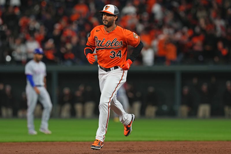 Oct 8, 2023; Baltimore, Maryland, USA; Baltimore Orioles center fielder Aaron Hicks (34) hits a three run home run during the ninth inning against the Texas Rangers during game two of the ALDS for the 2023 MLB playoffs at Oriole Park at Camden Yards. Mandatory Credit: Mitch Stringer-USA TODAY Sports