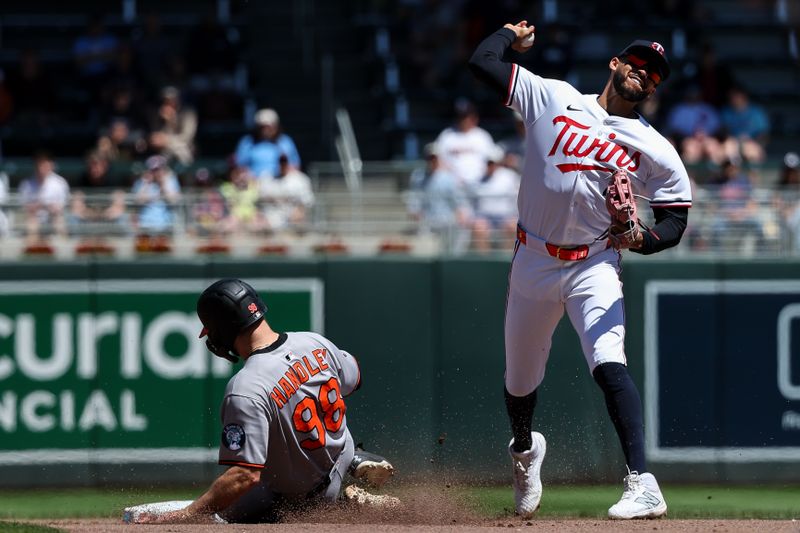 May 8, 2025; Minneapolis, Minnesota, USA; Minnesota Twins shortstop Carlos Correa (4) turns a double play against the Baltimore Orioles during the fourth inning at Target Field. Mandatory Credit: Matt Krohn-Imagn Images