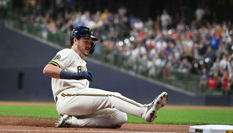 Aug 7, 2023; Milwaukee, Wisconsin, USA; Milwaukee Brewers third baseman Brian Anderson (9) slides safely into third base for a triple against the Colorado Rockies in the fourth inning at American Family Field. Mandatory Credit: Michael McLoone-USA TODAY Sports