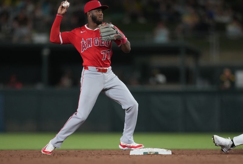 May 21, 2025; West Sacramento, California, USA; Los Angeles Angels second baseman Tim Anderson (77) turns a double play against the Athletics in the sixth inning at Sutter Health Park. Mandatory Credit: Cary Edmondson-Imagn Images