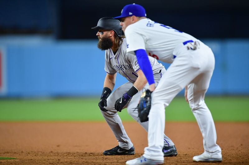 May 31, 2024; Los Angeles, California, USA; Colorado Rockies right fielder Charlie Blackmon (19) leads off from first ahead of Los Angeles Dodgers first baseman Freddie Freeman (5) during the seventh inning at Dodger Stadium. Mandatory Credit: Gary A. Vasquez-USA TODAY Sports