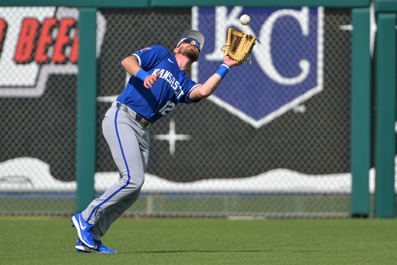 Feb 20, 2026; Surprise, Arizona, USA;  Kansas City Royals left fielder Nick Loftin (12) makes a play at the fence in the fifth inning against the Texas Rangers at Surprise Stadium. Mandatory Credit: Jayne Kamin-Oncea-Imagn Images