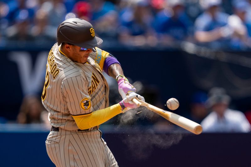 Jul 20, 2023; Toronto, Ontario, CAN; San Diego Padres third baseman Manny Machado (13) cracks his bat during the sixth inning against the Toronto Blue Jays at Rogers Centre. Mandatory Credit: Kevin Sousa-USA TODAY Sports