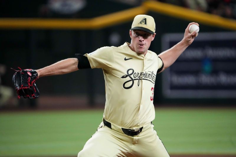 Aug 13, 2024; Phoenix, Arizona, USA; Arizona Diamondbacks pitcher Joe Mantiply (35) pitches against the Colorado Rockies during the ninth inning at Chase Field. Mandatory Credit: Joe Camporeale-USA TODAY Sports